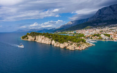 Aerial drone view . Beautiful coastline, white pier going into the sea, blue sea. Makarska is a...