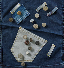 Several buttons on the jeans fabric. Up view.