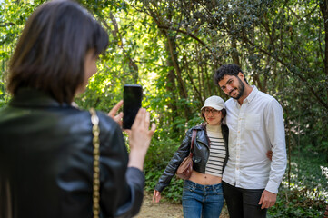 three friends taking pictures with their cell phones