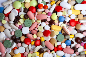 Fototapeta na wymiar Colored pills, tablets and capsules background