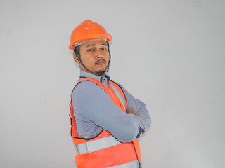 Asian constructor worker man with safety vest stand croosed his arm with confidence gesture