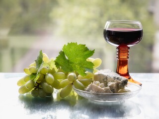 Red  wine glass and grapes with cheese