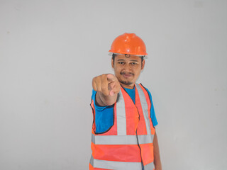 A man wearing construction pointing forward gesture choosing someone against white background