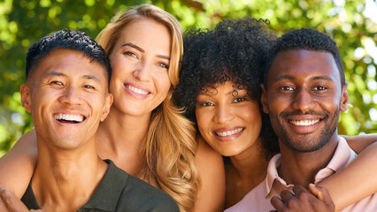 Portrait Of Multi-Racial Couple With Friends Hugging Outdoors  In Countryside In Group Together