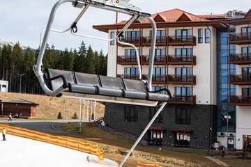 ski lift without people on a sunny day with skiers on the slope. Leisure. school break