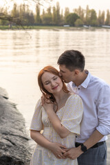 Couple in love hugging and kissing on seashore in sea.