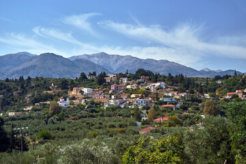 A town in the valley and rocky peaks in the Lefka Ori mountains on the island of Crete