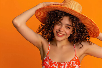 An individual dressed for summer, beaming with joy as they lift their hat in greeting against an orange backdrop. This image portrays the delight of a summer holiday experience.