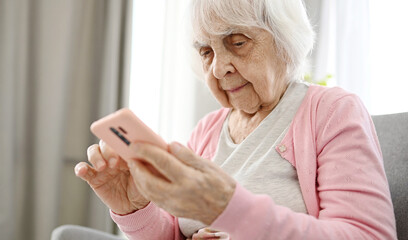 Elderly Woman Using Smartphone Reading Internet News, Close Up View