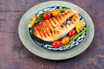 Grilled trout steak on a plate.
