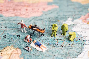 Figurines on map of China. Virus fighting concept.