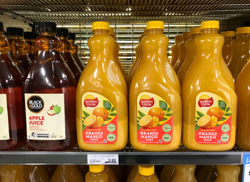 South Australia, Australia – April 25, 2024: Bottles of Black And Gold apple juice and Golden Circle orange mango juice on supermarket shelf