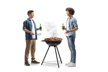 Friends grilling meat on a barbecue and holding bottle of beer