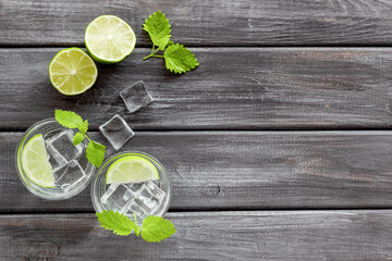 Refreshing cocktail mojito with mint and ice cubes in glasses, top view