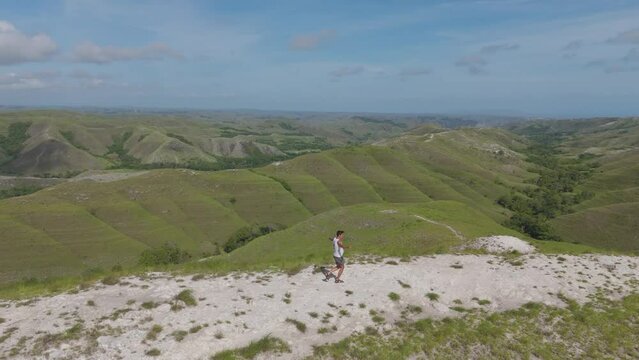 Aerial drone flyover shot of the green valleys and cliffs in Indonesia.