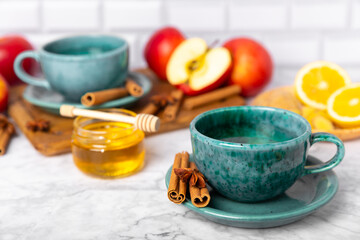 Fragrant hot tea with cinnamon stick and anise on a textured wooden background. A cup of hot tea...