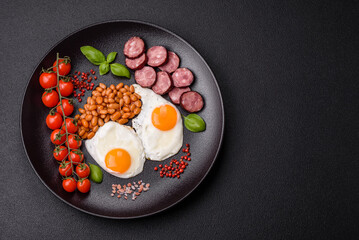 English breakfast with fried eggs, bacon, beans, tomatoes, spices and herbs
