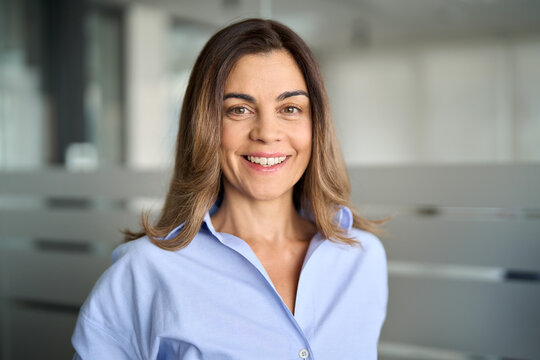 Happy middle aged business woman attorney, smiling 45 years old lady entrepreneur, mature female professional executive manager leader standing in office looking at camera. Headshot portrait.