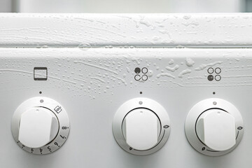 detergent foam on gas stove control panel