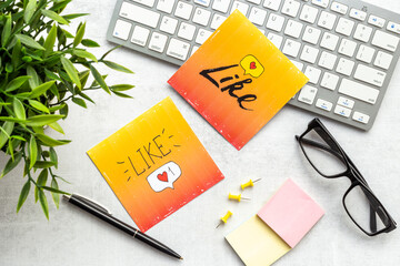 Social media icons on the table with keyboards and stationery