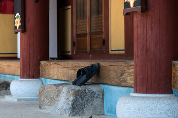 View of the slippers in front of the Buddhist temple building