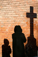 Woman praying the cross. Faith and religion.