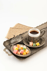 Turkish Coffee with Turkish Delight on authentic metal plate, isolated on white background