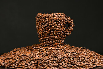 Cup of coffee made from roasted coffee beans isolated on black background