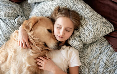 Cute Little Girl Hugging Dog And Sleeping In Bed