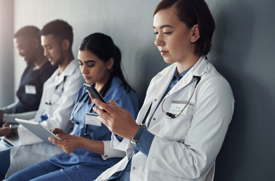 Chairs, team and technology with doctors by wall for interview or public health conference and training meeting. People, medical staff and line for patient rounds or daily briefing, review and online