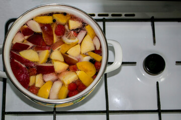 Compote of apples and strawberries. Compote with apples and strawberries. Hot drink. We prepare compote at home. View from above.