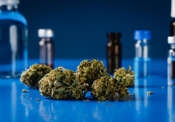 cannabis buds and laboratory flasks - 796604356