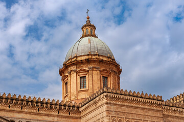 Fototapeta na wymiar Majestic dome of Palermo Cathedral against blue sky in southern Italy.