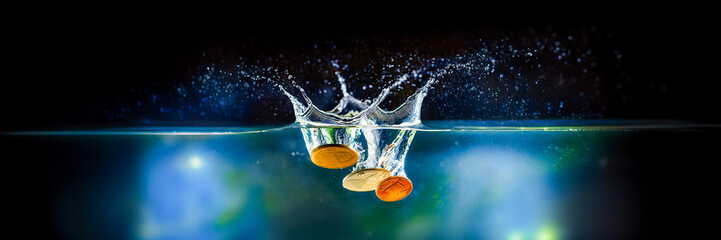 coin fall in water drop