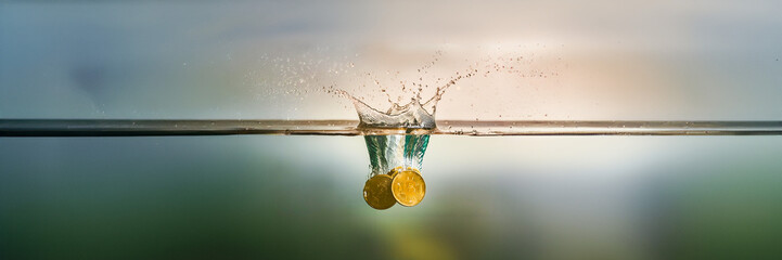 crypto gold coin fall in water under horizon