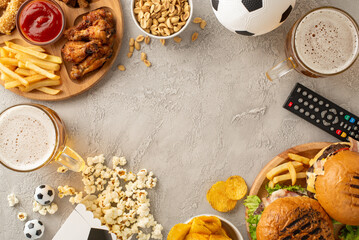 Soccer match vibe. Top view of delicious treats: tortilla chips with dip, nuts, popcorn, chicken...