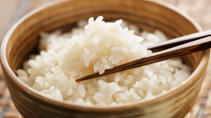 A close-up shot of scooping rice with chopsticks