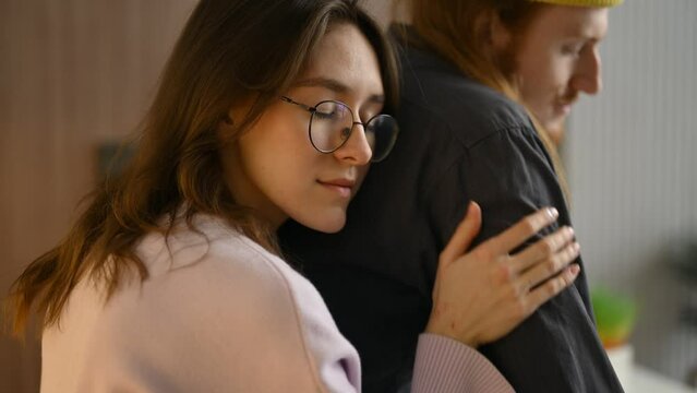 Young woman giving support and hugging her boyfriend, close up