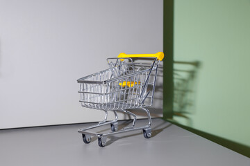 A replica photo of a  mini shopping cart was place in a gray table
