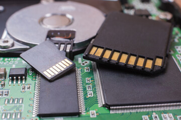 A close-up of a memory card and a hard disk on the concept of technology development