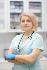 Vertical portrait of beautiful female doctor during appointment of patient in office a modern clinic. Skillful woman veterinarian is at the workplace in vet hospital. - 796647543