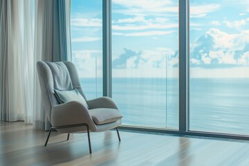Fototapeta premium A view from the chair beside the window: As the morning rises, the apartment becomes a cozy retreat where residents can unwind and admire the twinkling sea view from the comfort of their own home