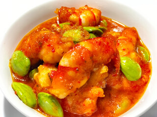 Petai or Pete with Shrimp, cooked with mashed red chili. This food is called Balado Udang Pete, isolated on dinner preparation. Selective focus.

