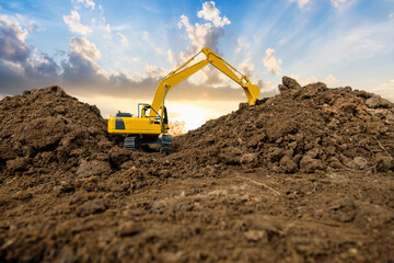 Crawler excavator with are digging the soil in the construction site on the sunset backgrounds