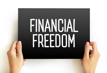 Financial Freedom - having enough savings, financial investments, and cash on hand to afford the kind of life we desire for our families, text concept on card - 796659513