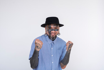 Fashionable Asian man with face and eye tattoos, including flesh tunnel and nose and lip piercings,...