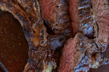 photo of close-up of argentinean asado. roast beef ribs, traditional Argentine food.. Barbecue