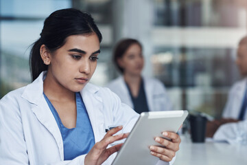 Tablet, research and woman doctor in hospital for meeting read medical communication online. Telehealth, email and professional healthcare worker scroll on internet with digital technology in clinic.