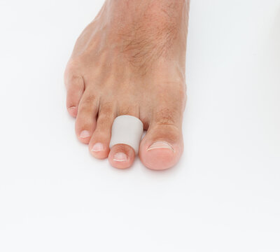 Feet silicone toe protector. Man wearing protector for claw or hammer toes