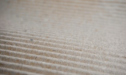 Close up wrinkled striped cardboard paper sheet material texture background isolated on horizontal...